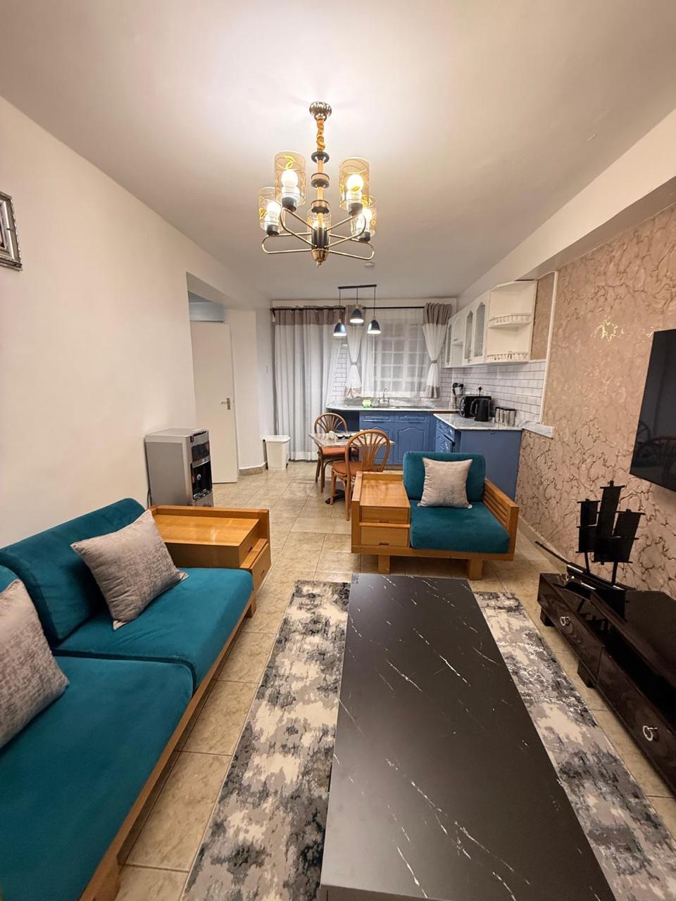 Luminus living room with teal sofa and chandelier